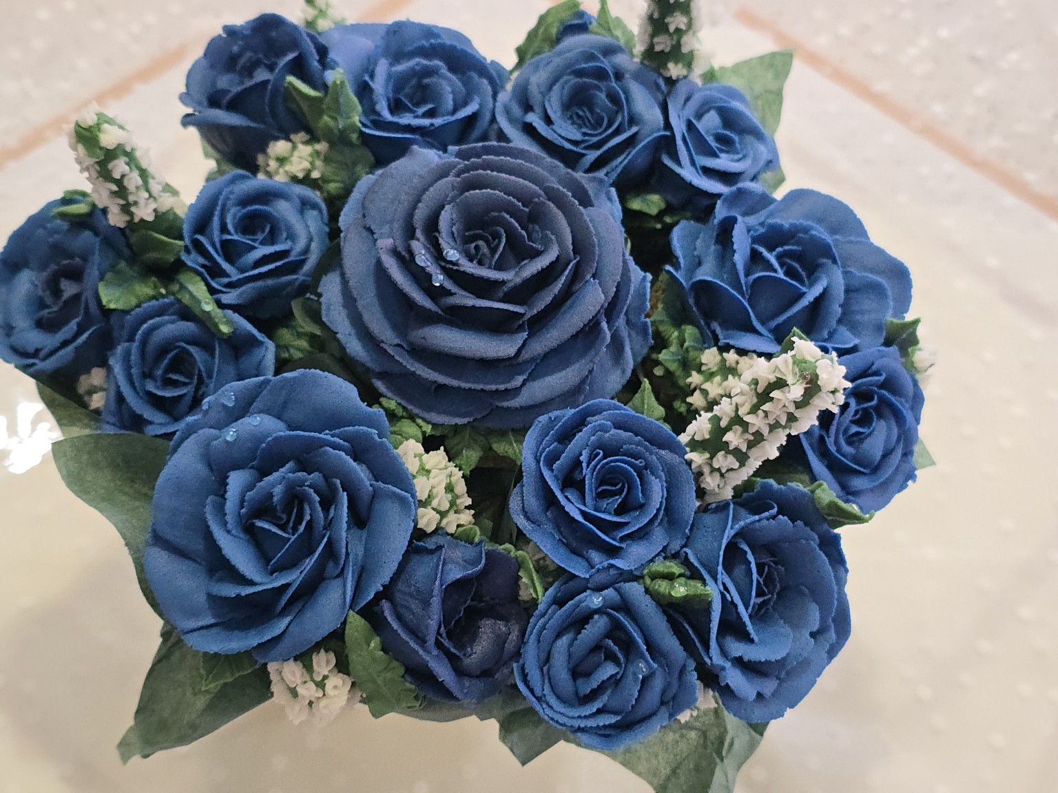 Deep blue and ivory buttercream floral cupcake bouquet